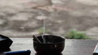Smoking cigarette in ashtray