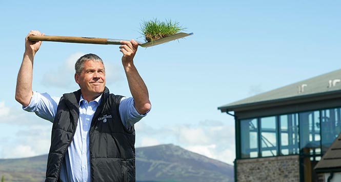 Alan Winchester holds spade aloft