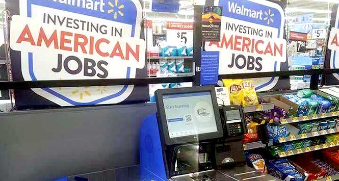 Self-scanning checkout with 'Walmart: investing in American jobs' sign