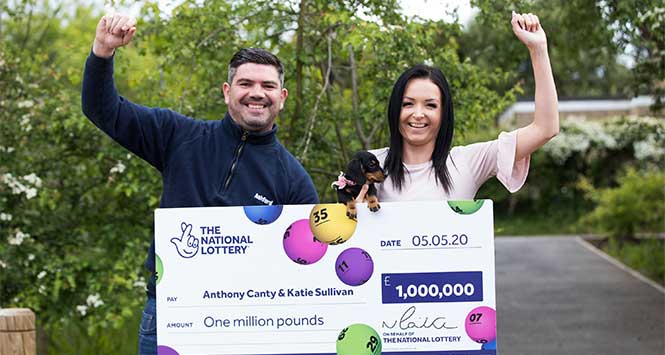 Couple holding giant cheque
