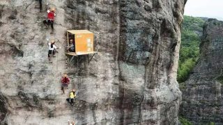Small lean-to shed attached to cliff-face