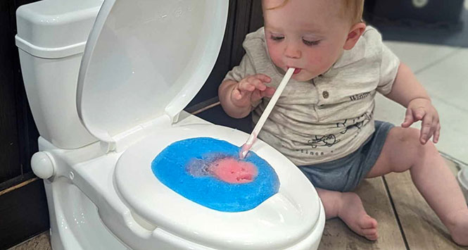 Baby drinking from toilet