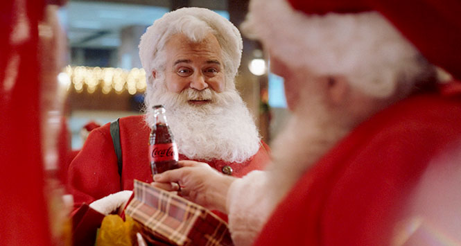 Santa holding a Coca-Cola