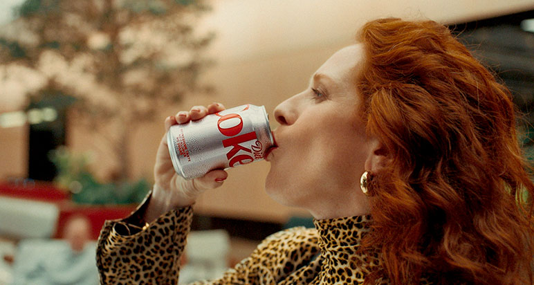 Woman in leopard print drinking Diet Coke